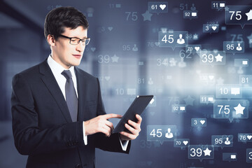 Corporate communication concept with smiling businessman with digital tablet on virtual interface with social media icons
