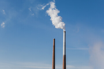 smoke get out of industrial chimney is a symbol for climate change and pollution and shows not...