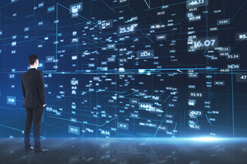 Analytics concept with businessman looking at media wall with stats data indicator
