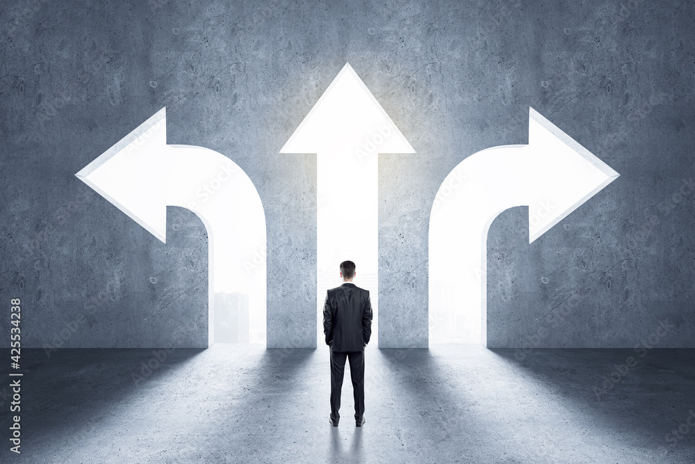 Aufkleber choice concept with businessman in front of arrow holes directed in different directions in wall