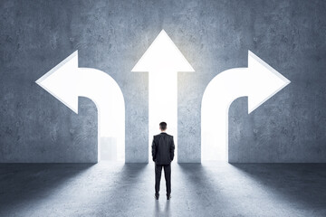Choice concept with businessman in front of arrow holes directed in different directions in wall