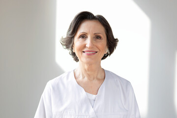 Portrait of mature female doctor on white background