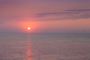 Amazing beach sunset with endless horizon. Horizontal. Selective focus.