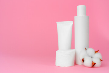Stack of cotton discs and skicare cosmetic bottle
