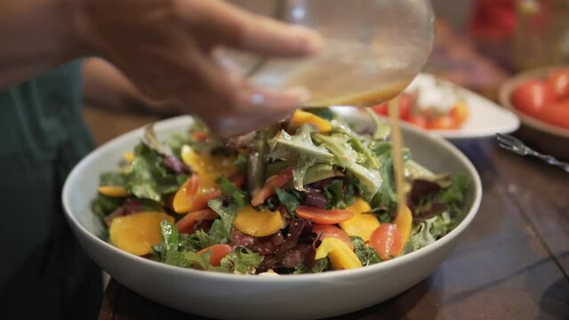 woman preparing cooking making vegetable salad in kitchen