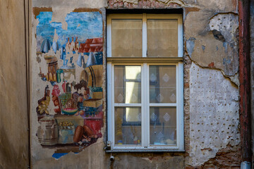 Fototapeta na wymiar LVIV, UKRAINE - April, 2021: Old window in an ancient building in Lviv, Ukraine. Ancient fresco.
