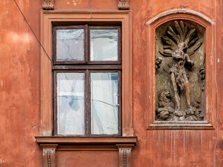 LVIV, UKRAINE - April, 2021: Vintage decorative wall with figure and window.