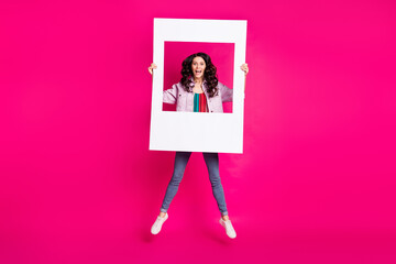 Full size photo of young funky funny smiling excited girl jumping with big white frame isolated on...