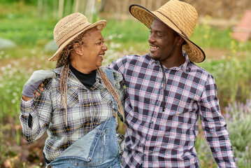 African farmers smile at the camera during the harvesting period - Farming lifestyle concept - Main focus on faces