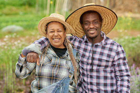 African farmers smile at the camera during the harvesting period - Farming lifestyle concept - Main focus on faces