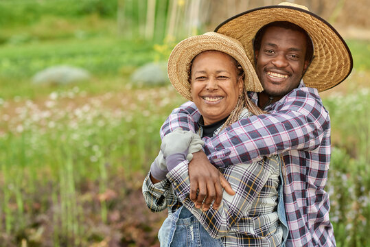 African farmers smile at the camera during the harvesting period - Farming lifestyle concept - Main focus on faces