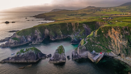 Dunquin Pier Ring of Dingle Kerry Ireland way cliffs coast line Irish touristic landmark sunset...