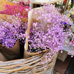 Beautiful summer flowers in the basket. Flowers basket on the street Flower market.