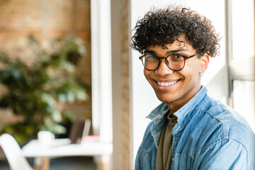 Close-up portrait of a mixed-race young man in the modern office