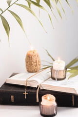 Easter evening with palm leaves, candles and bible next to the icon, Easter theme