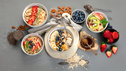 Fototapeta na wymiar Oatmeal bowls with delicious fruits and fresh berries on light background.