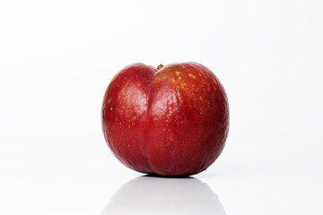 Ripe plum isolated on white background with shadow and reflection. Overripe old ugly plum. Spoiled food