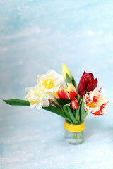 A bunch of tulips on the window. Still life with colorful tulip flowers bouquet  on window sill