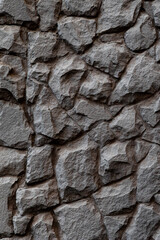 Dark masonry wall texture. Black stones and rocks of different shape, gray background, texture for interior and exterior design, vertical format banner