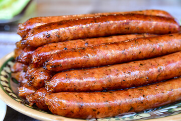 Grilled sausages appetizingly lie on a plate with a neat slide.