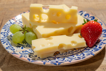 Cheese collection, blocks of French emmentaler cheese with many round holes made from cow milk