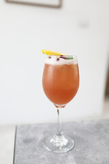 Pink Cocktail glass with ice at gray table
