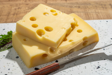 Cheese collection, blocks of French emmentaler cheese with many round holes made from cow milk