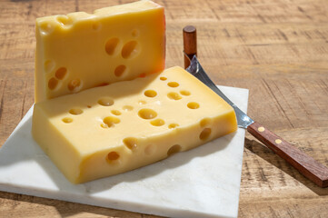 Cheese collection, blocks of French emmentaler cheese with many round holes made from cow milk
