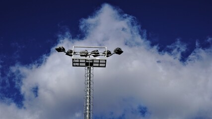 stadium lights against cloudy sky