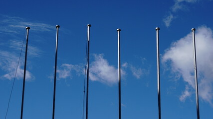 empty flagpoles against sky background