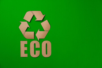 Paper recycling concept on green background top view