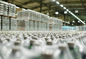 Obraz premium Food industrial warehouse for storage and storage of packagings with drinks, water, beer in plastic PET bottles.