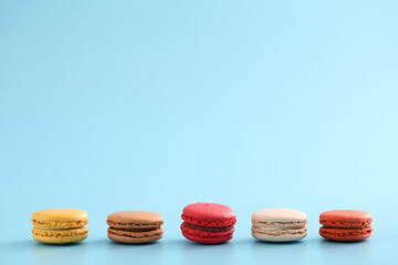 Colorful macarons isolated in blue background
