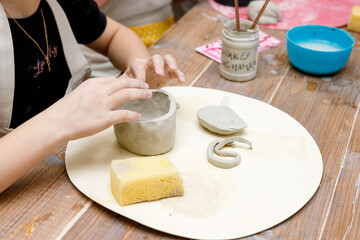 the child sculpts from clay