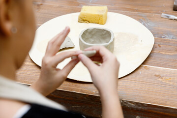 the child sculpts from clay