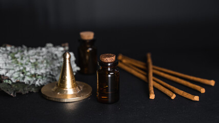 Obraz na płótnie Canvas Aromatherapy at home for mind and body fulfilment. Essential oil vintage bottle surrounded by incense sticks and anise seeds. Perfumery background. 