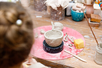 the child sculpts from clay