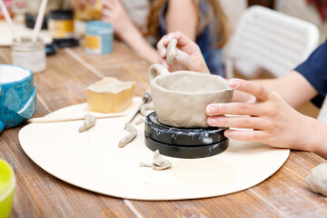 the child sculpts from clay