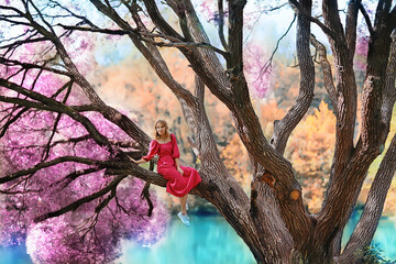 springtime dreaming female girl sitting on a tree branch, spring forest park