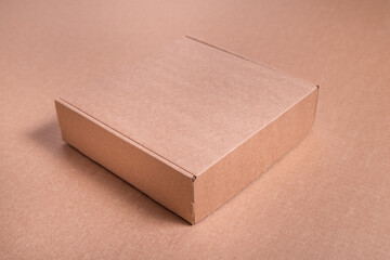 Brown cardboard flat box on brown background