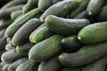 cucumbers on market counter in wicker basket