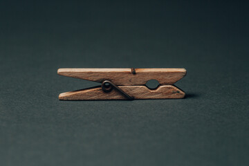 single wooden laundry washing peg on black background. High quality photo