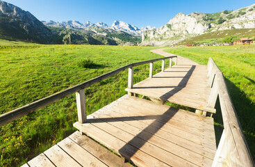Fototapeta na wymiar view with a wooden walkway to national park peaks of europe