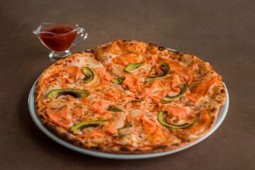 Pizza with salmon and avocado on a plate