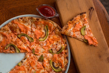 Pizza with salmon and avocado in box