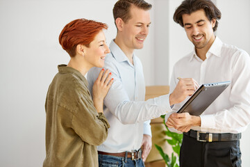 Real estate agent talking about terms of home purchase agreement showing it on digital tablet