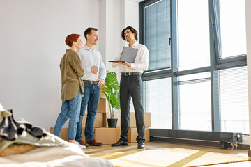 Confident caucasian real estate agent with House model on laptop is talking to clients about buying...