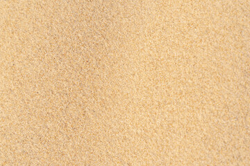 Naklejka na ściany i meble Sand texture background on the beach. Light beige sea sand texture pattern.