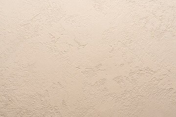 the background of the wall is beige plaster. scratches and bumps concrete gray background