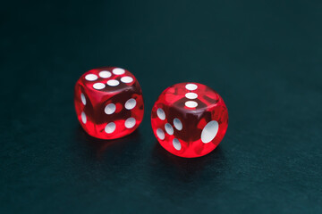 Red dice made of plastic for gambling lie on the table